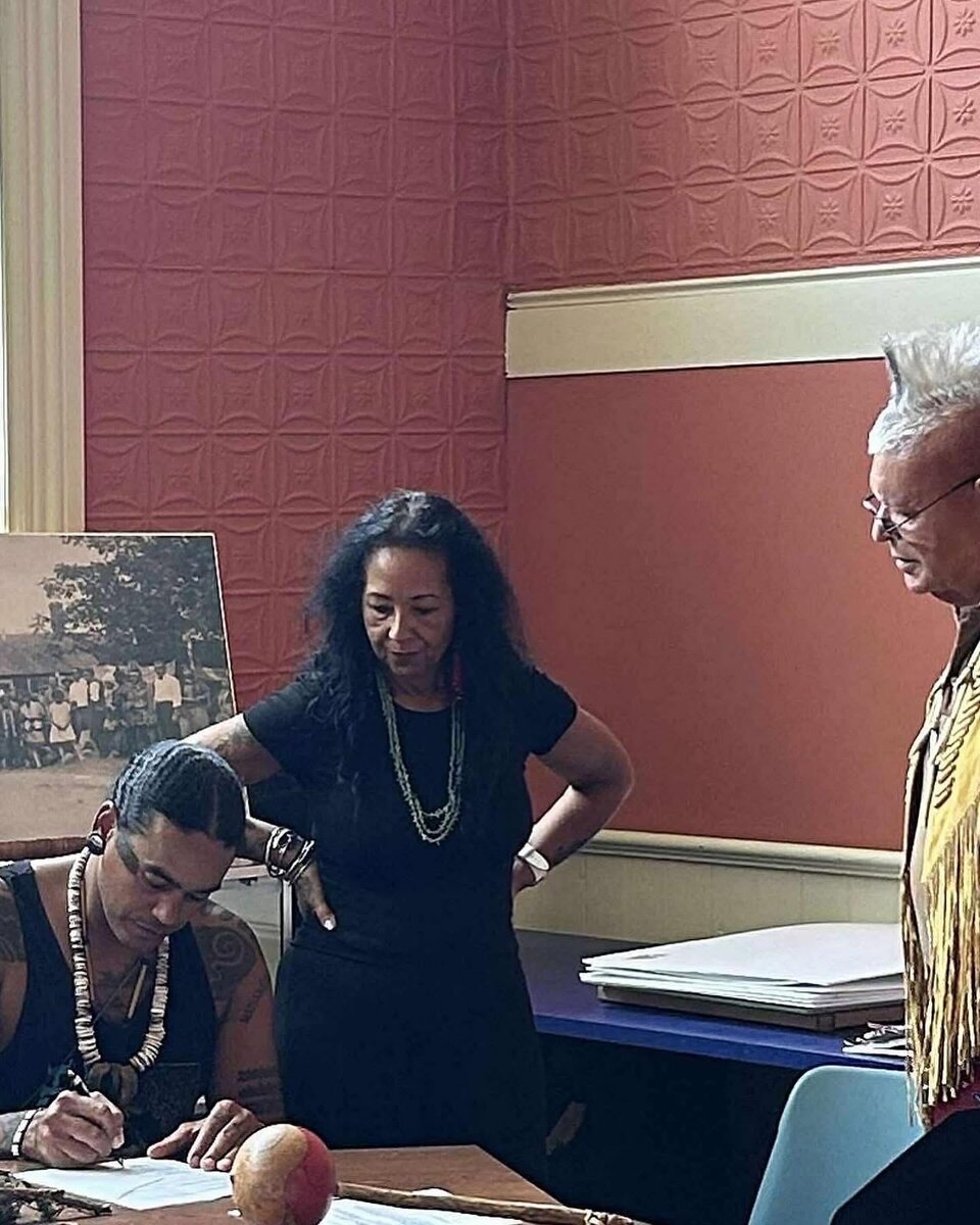 THPO Andre Gaines-Roberson signing tribal documents alongside Tribal Council members