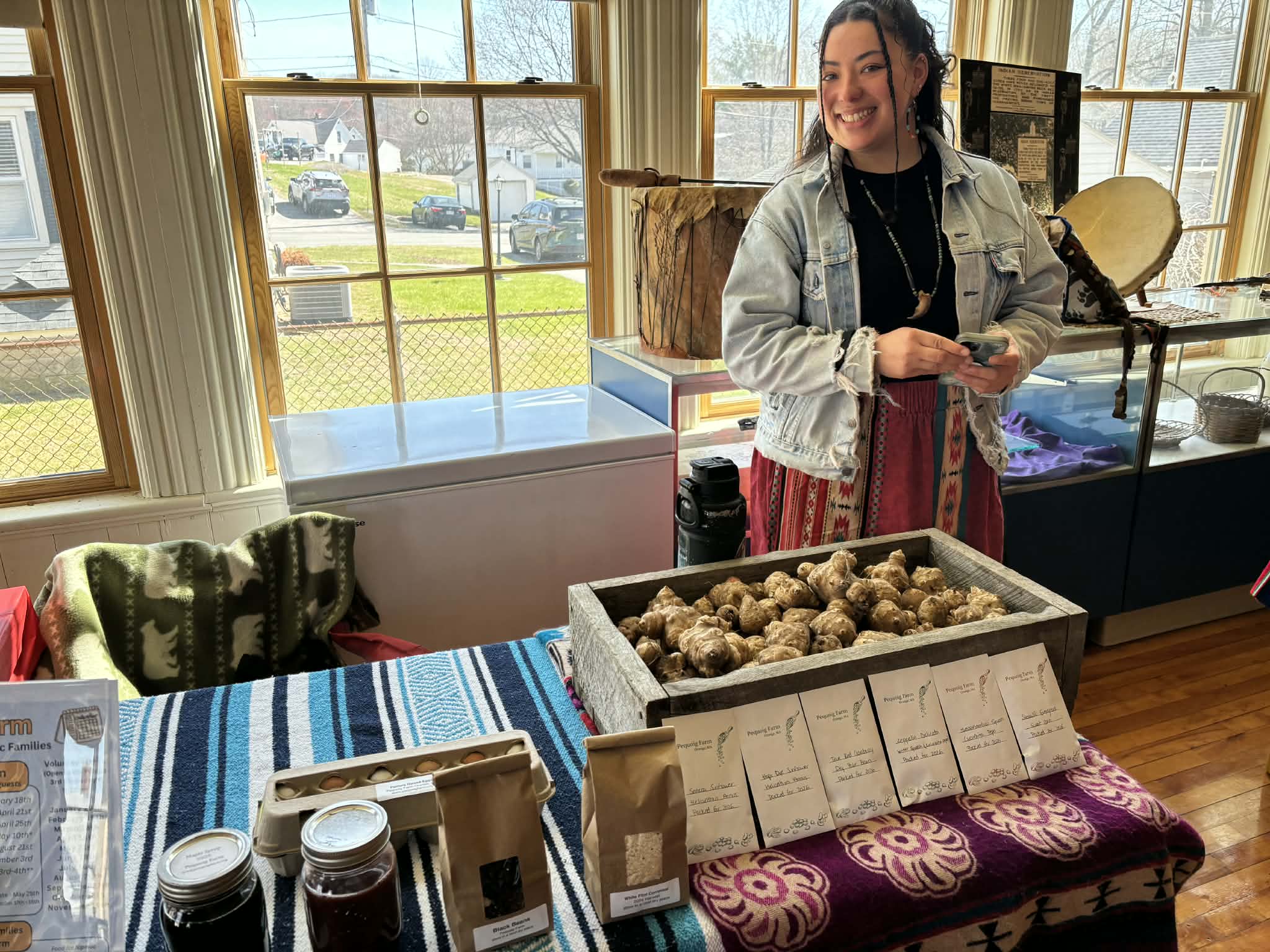 Pequoig Farm table display with sunchokes, seed packets, and preserves
